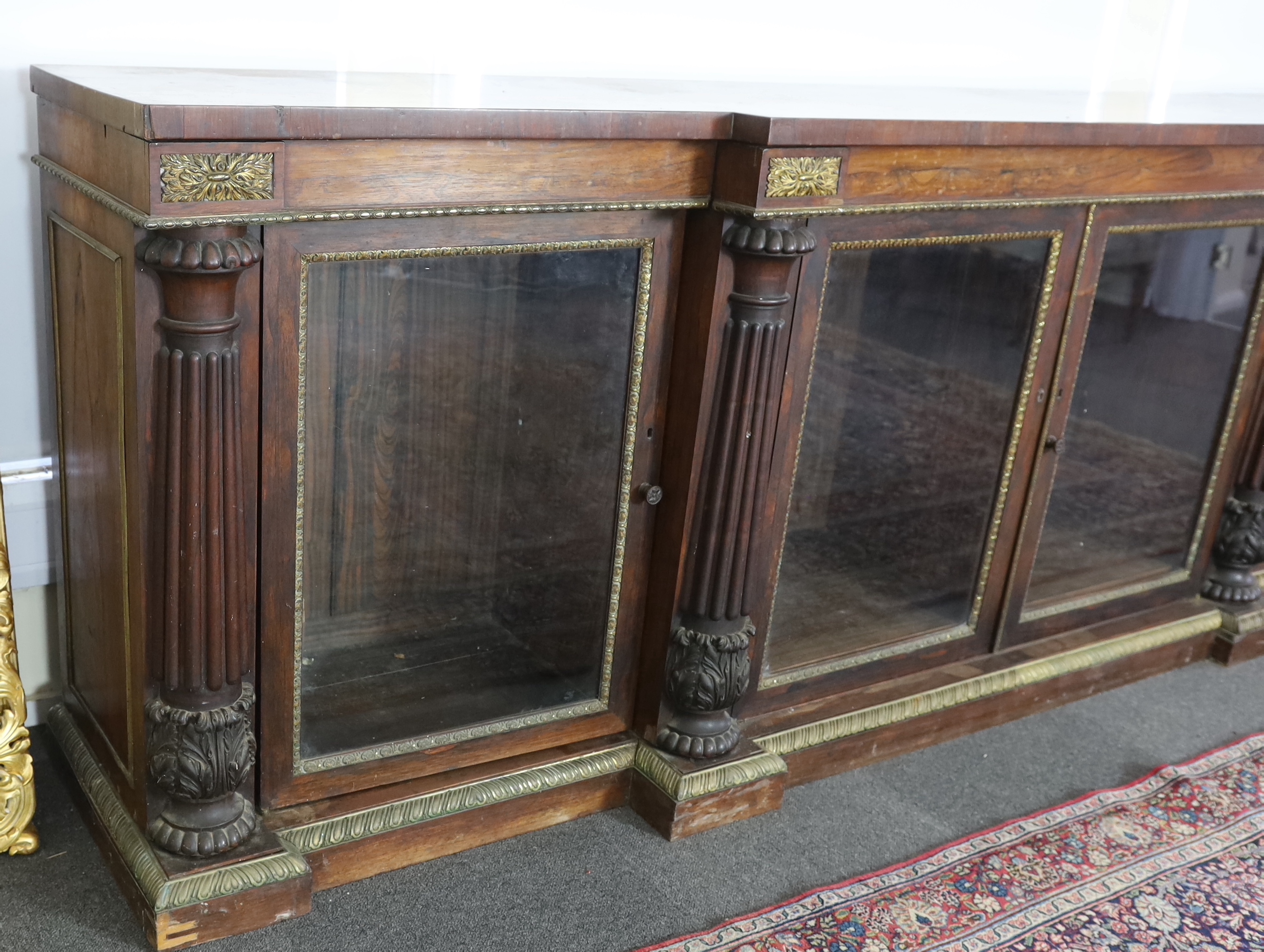 A George IV ormolu mounted rosewood breakfront dwarf bookcase, width 306cm, depth 60cm, height 102cm